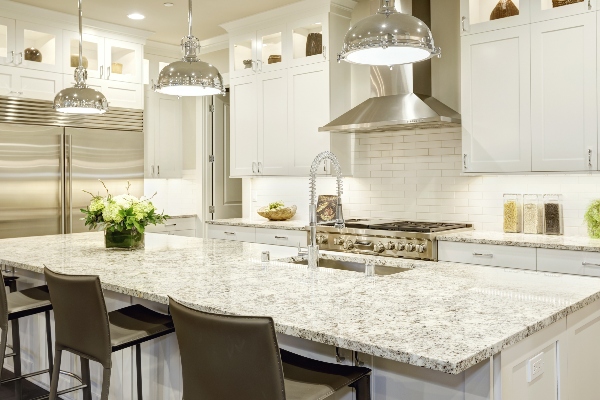 A fully furnished kitchen displays a marble countertop, one of the best choices available.