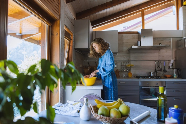 A homeowner prepares a meal in their remodeled kitchen.